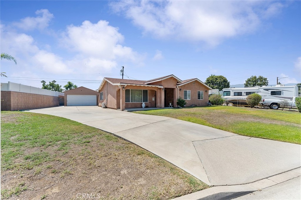 5441 North Calera Avenue Covina, CA 91722 - Photo 2 of 32 a front view of a house with a yard and garage