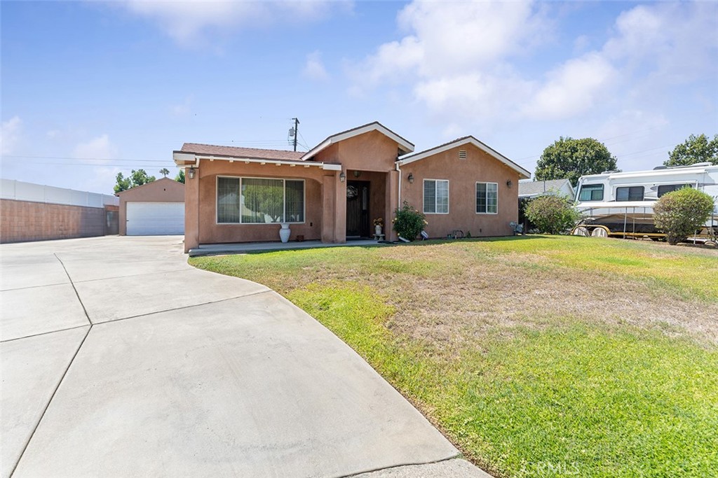 5441 North Calera Avenue Covina, CA 91722 - Photo 3 of 32 a front view of a house with a yard and garage