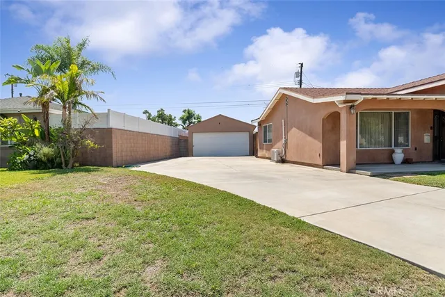 a view of a house with a yard and a garage