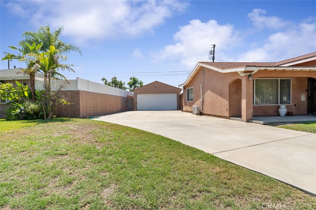 5441 North Calera Avenue Covina, CA 91722 - Photo 4 of 32 a view of a house with a yard and a garage