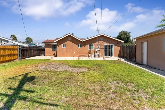 a front view of a house with a big yard