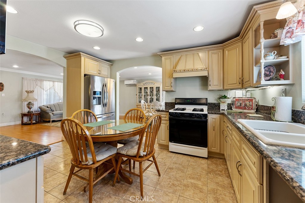 5441 North Calera Avenue Covina, CA 91722 - Photo 9 of 32 a kitchen with a stove a sink and a refrigerator