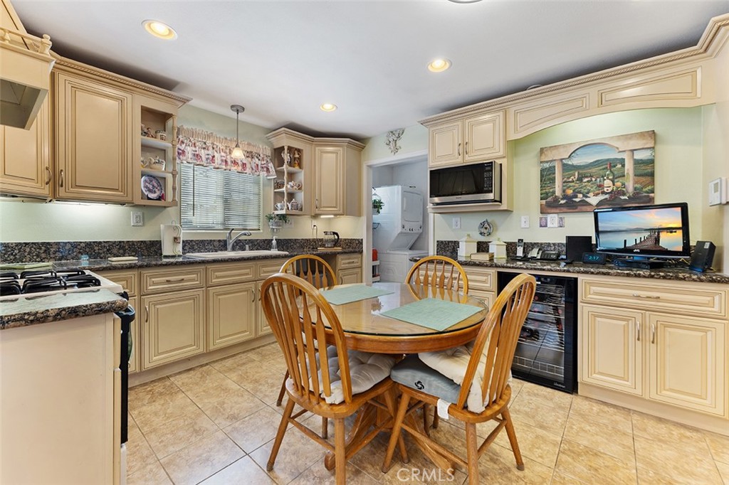 5441 North Calera Avenue Covina, CA 91722 - Photo 10 of 32 a kitchen with a dining table chairs and a refrigerator