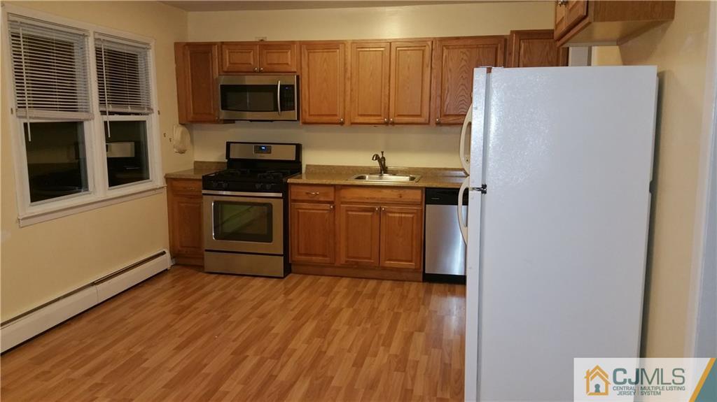 a kitchen with stainless steel appliances a stove a microwave and a refrigerator