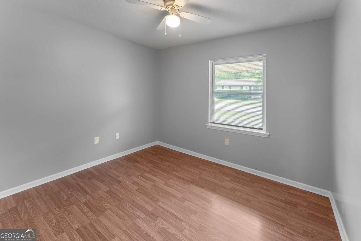 320 West Whatley Street Pooler, GA 31322 - Photo 10 of 34 wooden floor in an empty room with a window