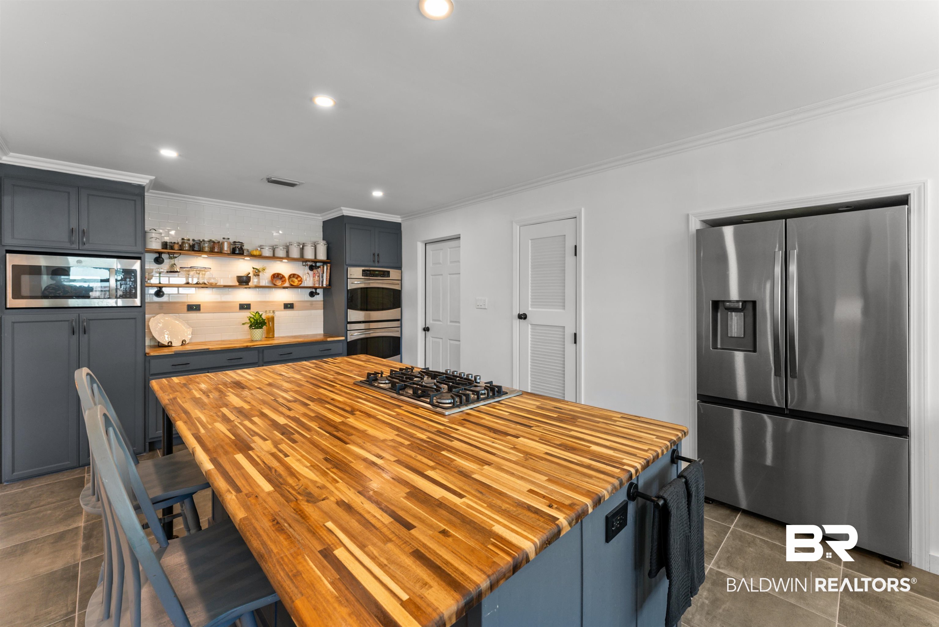 6447 Bemis Lane Bon Secour, AL 36511 - Photo 11 of 62 Kitchen featuring a large butcher block island with a gas cooktop, recessed lighting, stainless steel appliances, and gray cabinetry