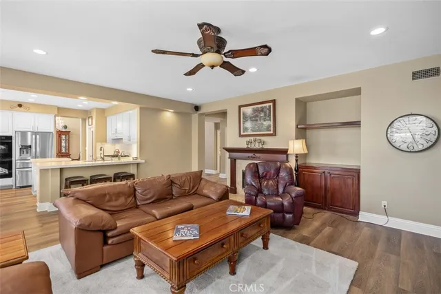 a living room with furniture a clock on wall and a table