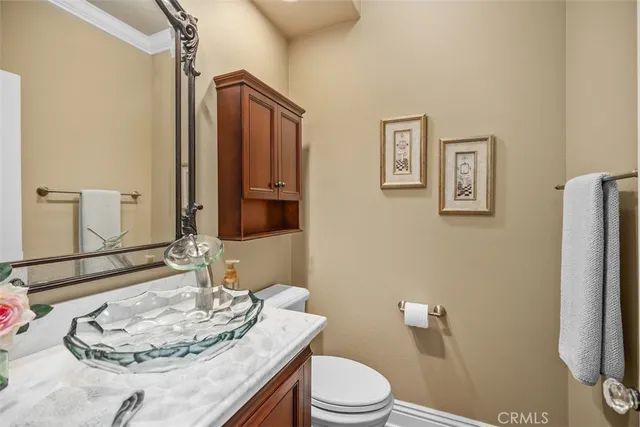 a bathroom with a granite countertop sink toilet a mirror and shower
