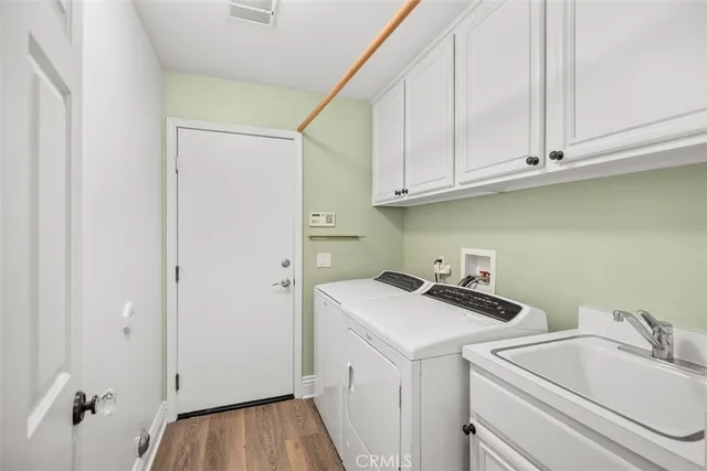 a view of a storage and utility room with a sink