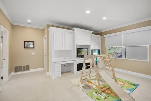 a living room with stainless steel appliances furniture and a table