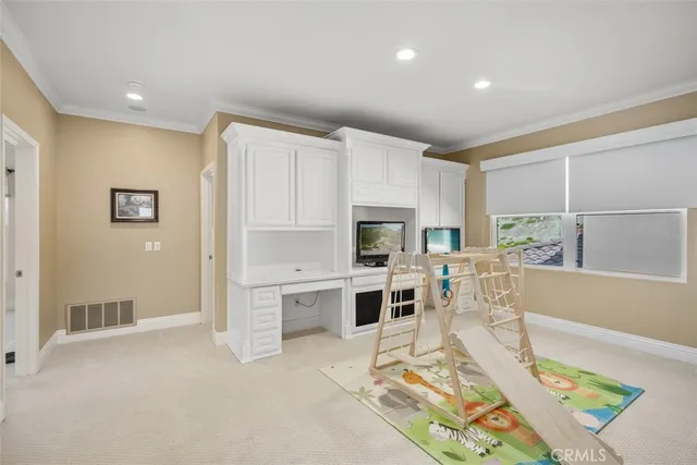 a living room with stainless steel appliances furniture and a table