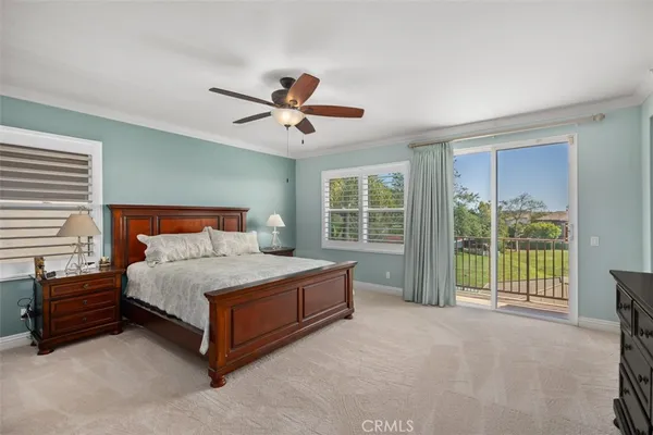 a spacious bedroom with a bed and a large window