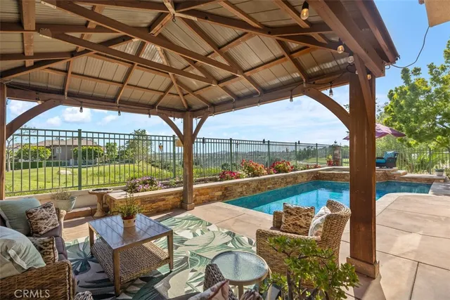 a view of a patio with furniture and a garden