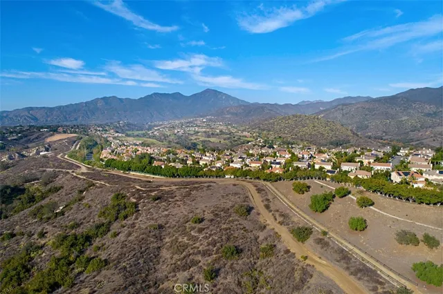 a view of a lush green hillside and houses
