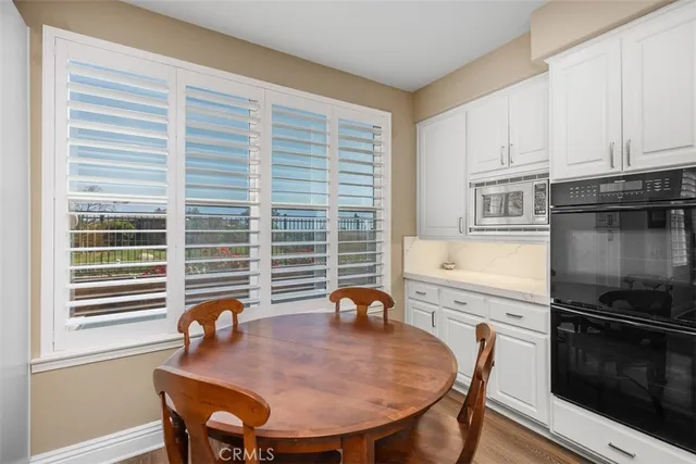 a view of a dining room with furniture and window