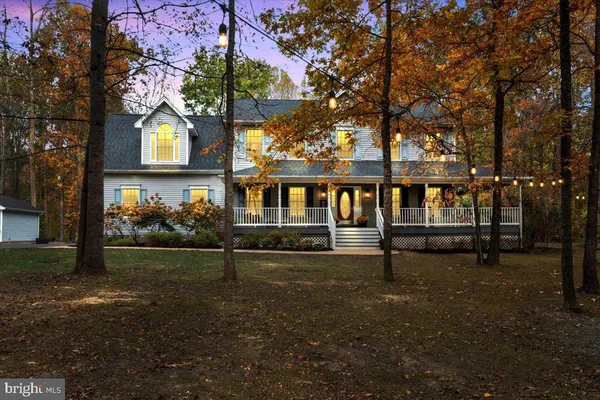 a view of backyard with large trees and wooden fence