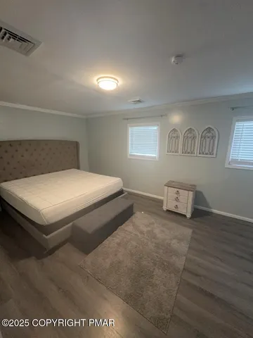 a spacious bedroom with a bed and a window