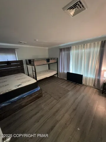 a view of room with hardwood floor and ceiling fan