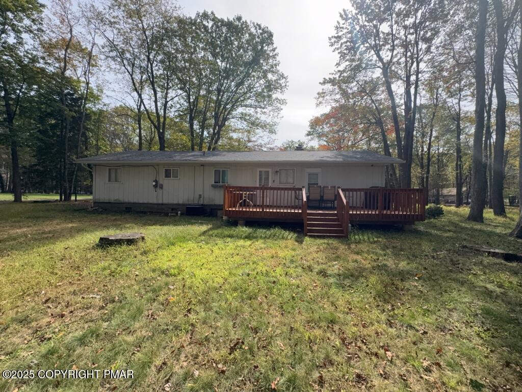 5228 Hummingbird Drive Pocono Summit, PA 18346 - Photo 19 of 28 a view of a house with a yard and sitting area