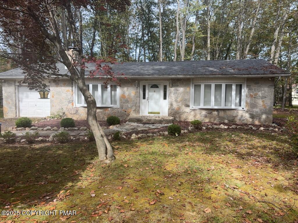 5228 Hummingbird Drive Pocono Summit, PA 18346 - Photo 2 of 28 a front view of a house with a yard