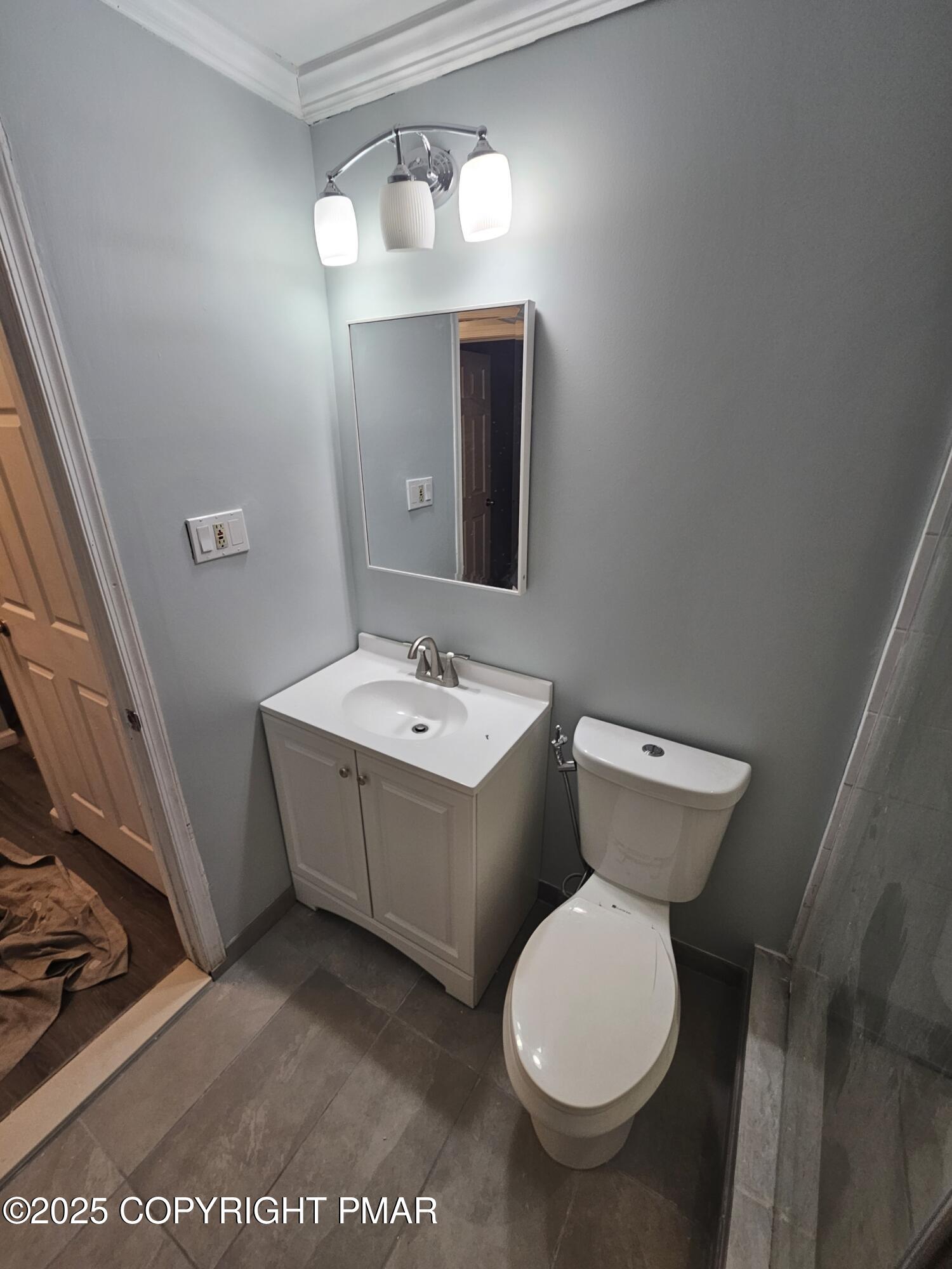 5228 Hummingbird Drive Pocono Summit, PA 18346 - Photo 21 of 28 a bathroom with a toilet sink and mirror