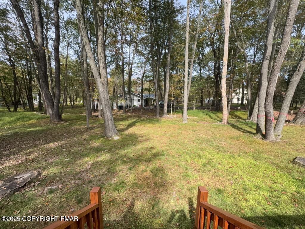 5228 Hummingbird Drive Pocono Summit, PA 18346 - Photo 22 of 28 a backyard of a house with table and chairs