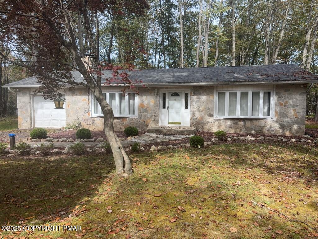 5228 Hummingbird Drive Pocono Summit, PA 18346 - Photo 28 of 28 a backyard of a house with table and chairs