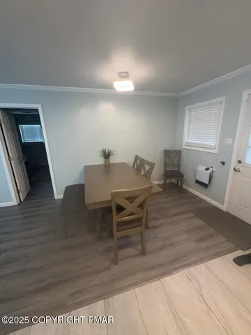 a view of a dining room with furniture and wooden floor