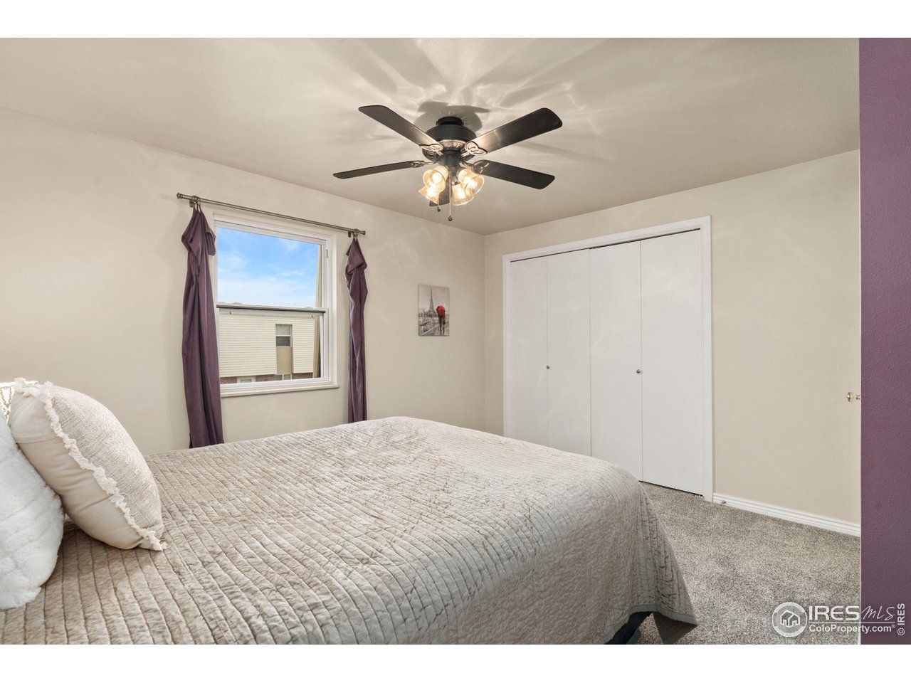 707 3rd Street, Unit 5 Windsor, CO 80550 - Photo 14 of 18 a bedroom with a bed and a chandelier