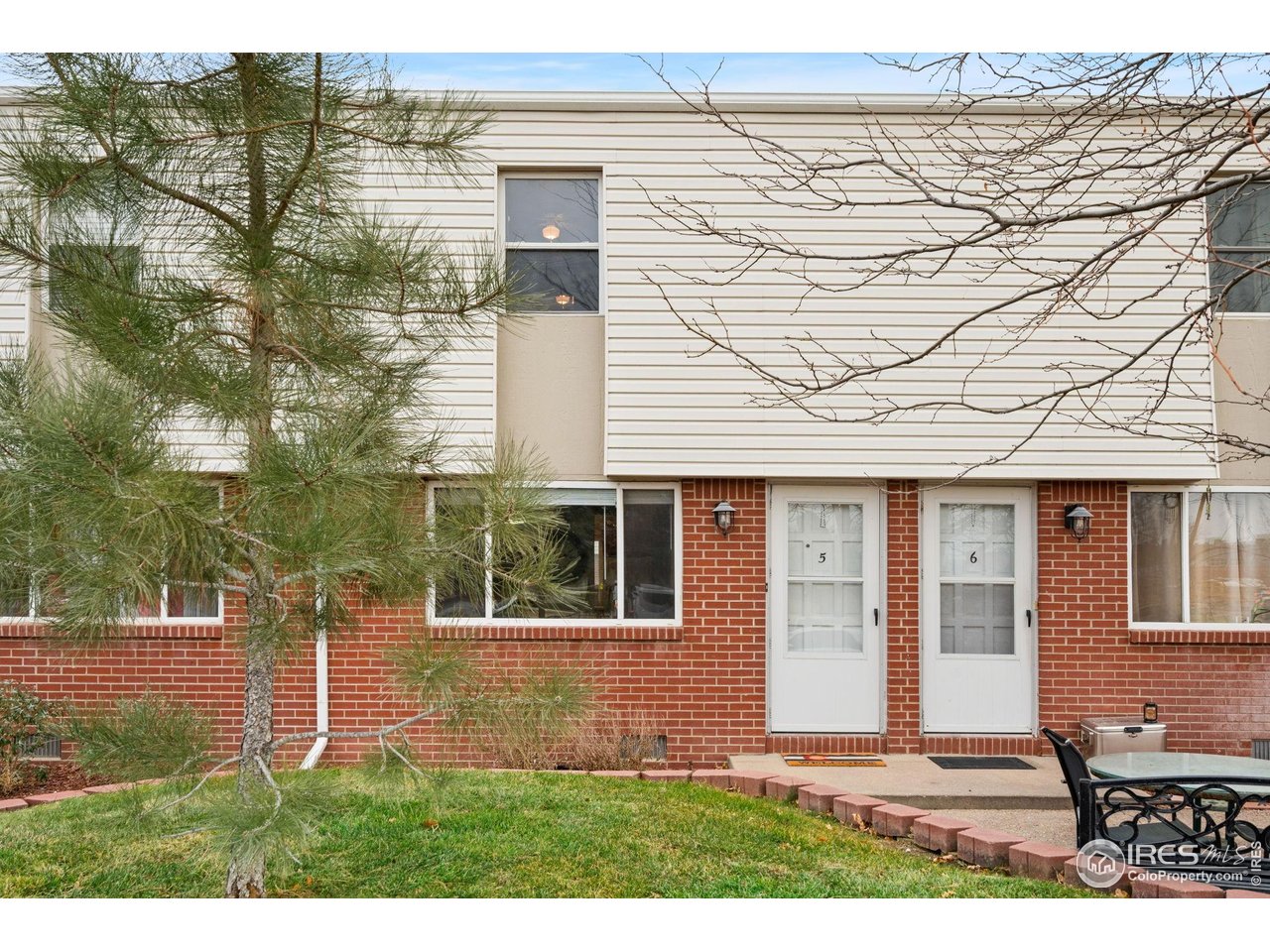 707 3rd Street, Unit 5 Windsor, CO 80550 - Photo 17 of 18 a front view of a house with a yard