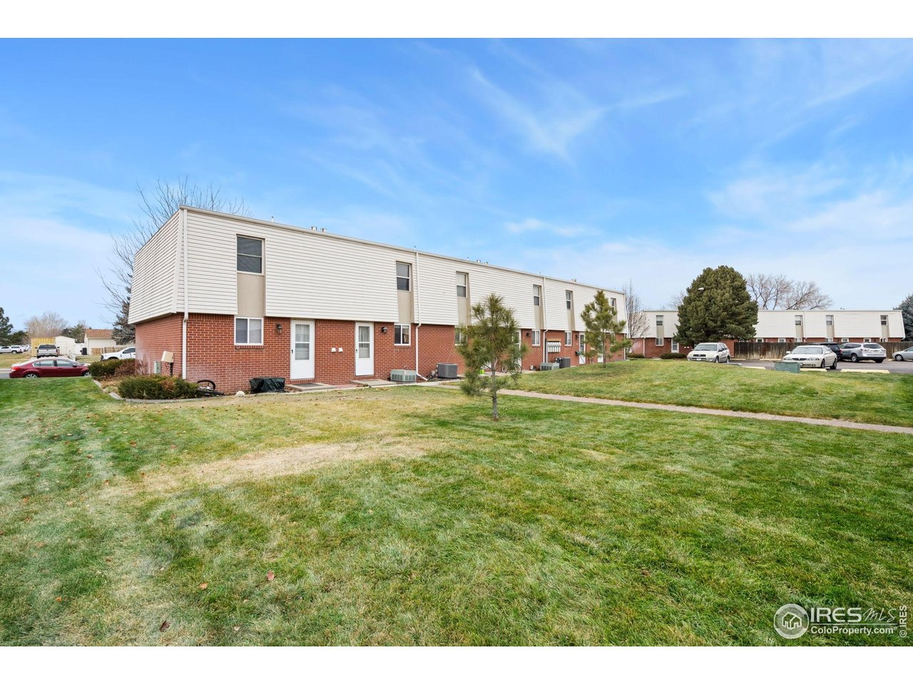 707 3rd Street, Unit 5 Windsor, CO 80550 - Photo 18 of 18 a view of a house with a big yard and large trees