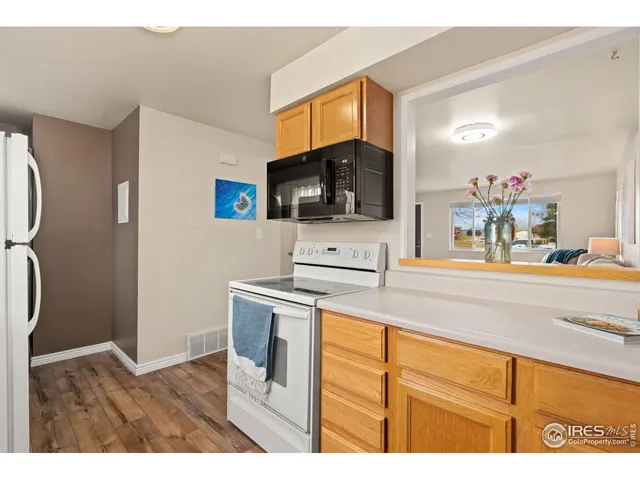 a kitchen with a sink cabinets and a wooden floor