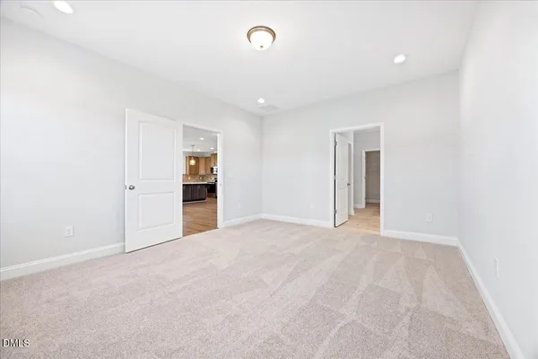 a view of an empty room with an entryway