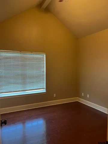 a view of a small space with wooden floor and a window