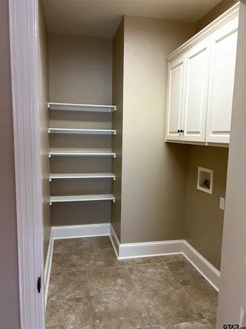 a view of room with cabinets and a window