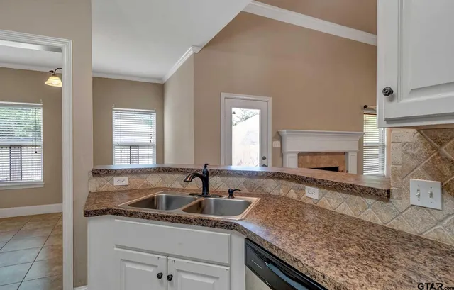 a kitchen with granite countertop a sink and a stove
