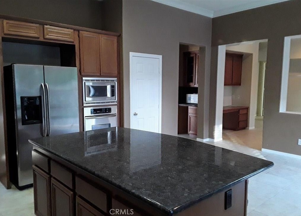 12701 Palm View Way Riverside, CA 92503 - Photo 14 of 26 a kitchen with stainless steel appliances granite countertop a sink a microwave and refrigerator