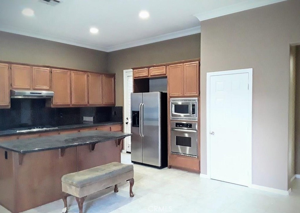 12701 Palm View Way Riverside, CA 92503 - Photo 18 of 26 a kitchen with stainless steel appliances granite countertop a refrigerator and a stove top oven