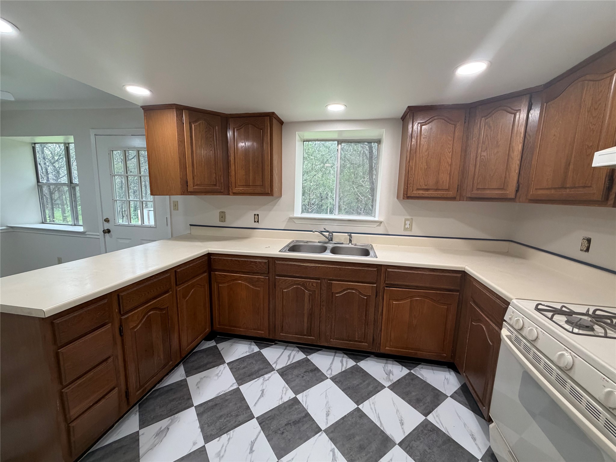 214 The Forest Road Dale, TX 78616 - Photo 9 of 18 A well-lit kitchen with ample cabinetry and a practical layout.