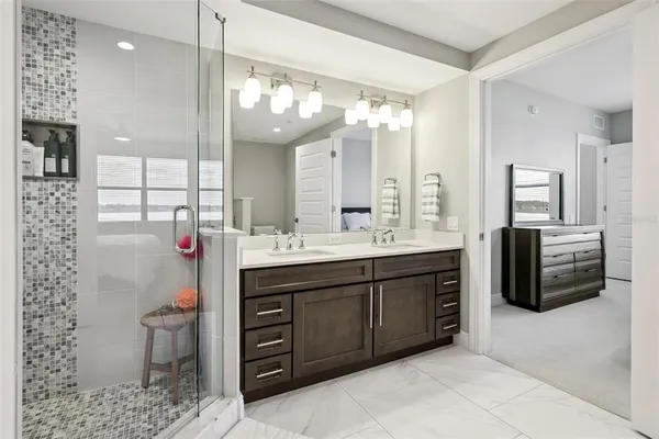 a bathroom with a double vanity sink mirror and toilet