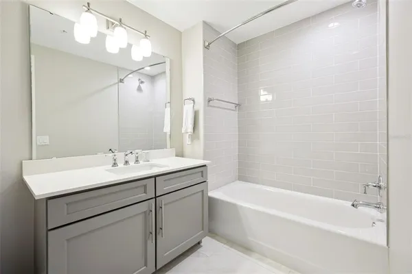 a bathroom with a bathtub a sink and a mirror