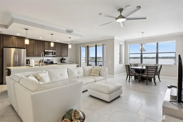 a living room with furniture a dining table and kitchen view