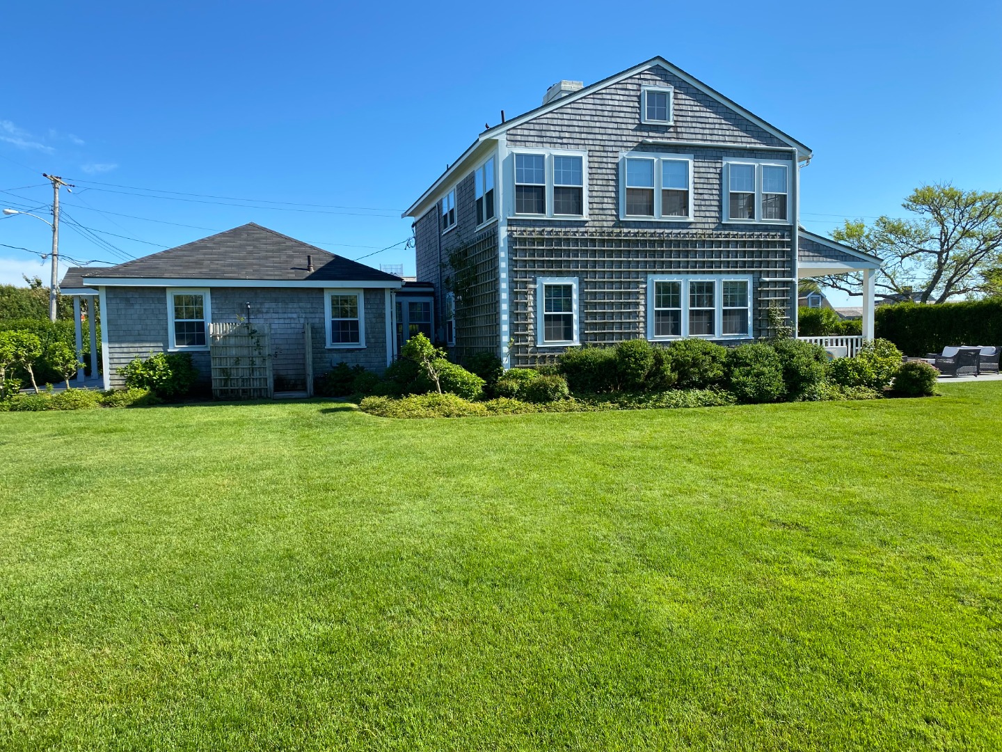 76 Baxter Road Nantucket, MA 02554 - Photo 5 of 25 a front view of a house with a yard