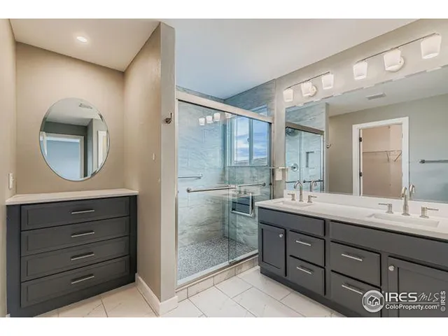 a bathroom with a double vanity sink mirror and bathtub
