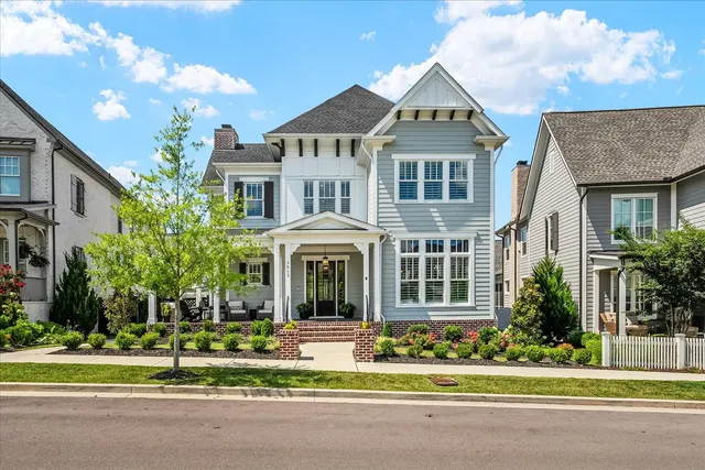 a front view of a house with a garden and plants