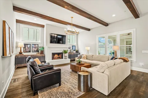 a kitchen with a sink a stove cabinets and wooden floor