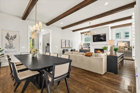 a kitchen with stainless steel appliances white cabinets and a wooden floor