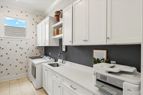 a view of a hallway with workspace and a window