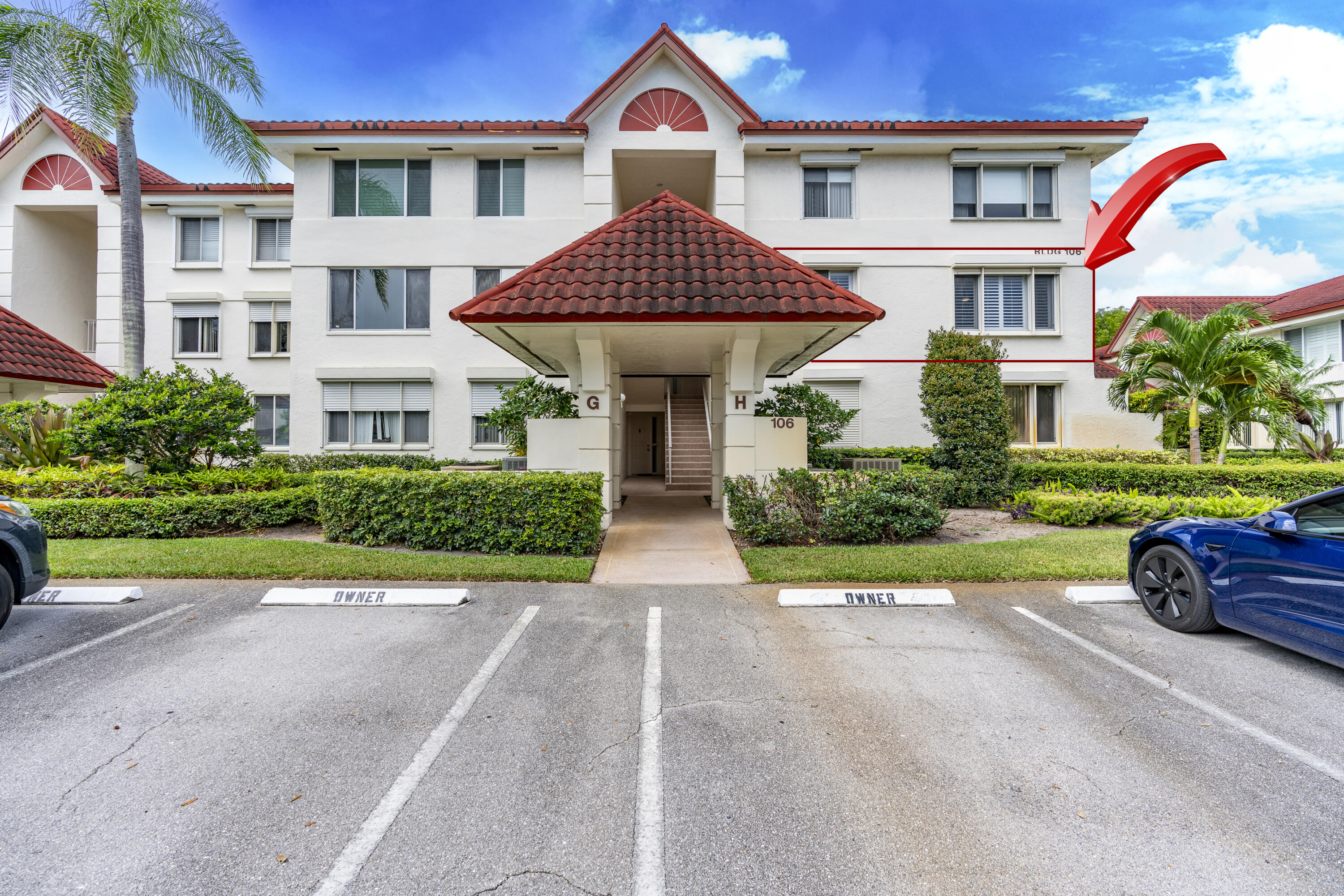 106 Half Moon Circle, Unit H2 Hypoluxo, FL 33462 - Photo 1 of 70 a front view of a house with a yard and potted plants