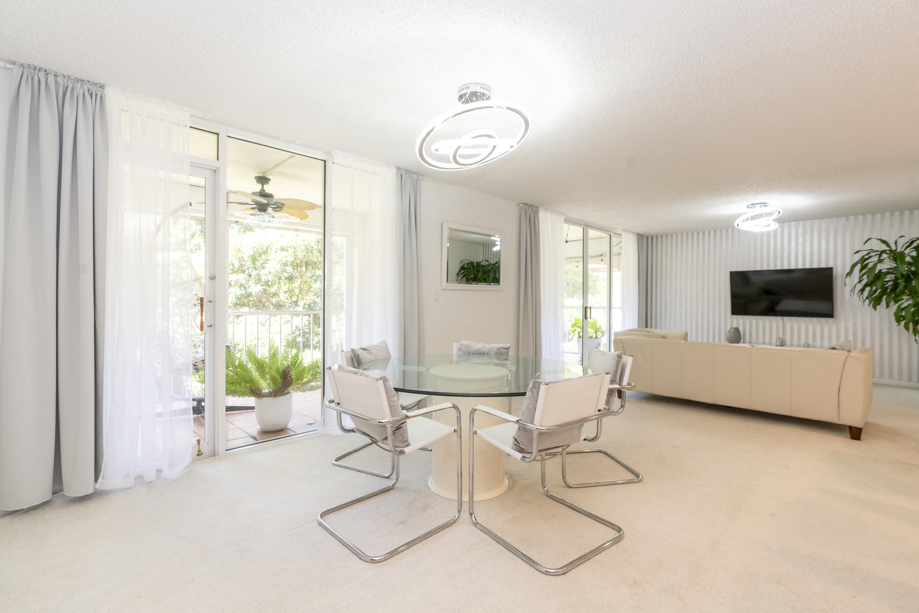 106 Half Moon Circle, Unit H2 Hypoluxo, FL 33462 - Photo 12 of 70 a living room with furniture and a large window